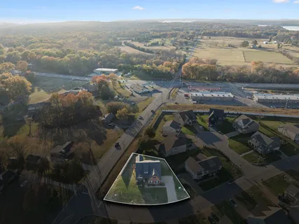 an empty room with a window and a ceiling fan