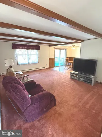 a view of a living room with furniture and a window