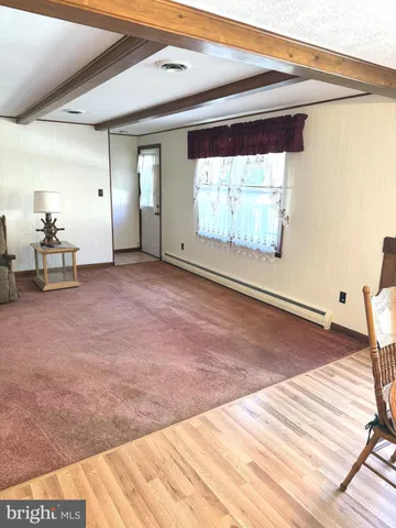 an empty room with windows and stairs