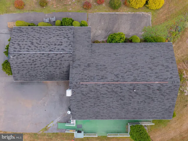 a bathroom with a granite countertop a sink and a shower