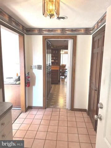 a living room with a bed furniture and a flat screen tv