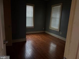 5945 Addison Road Capitol Heights, MD 20743 - Photo 6 of 9 a view of an empty room with wooden floor and a window