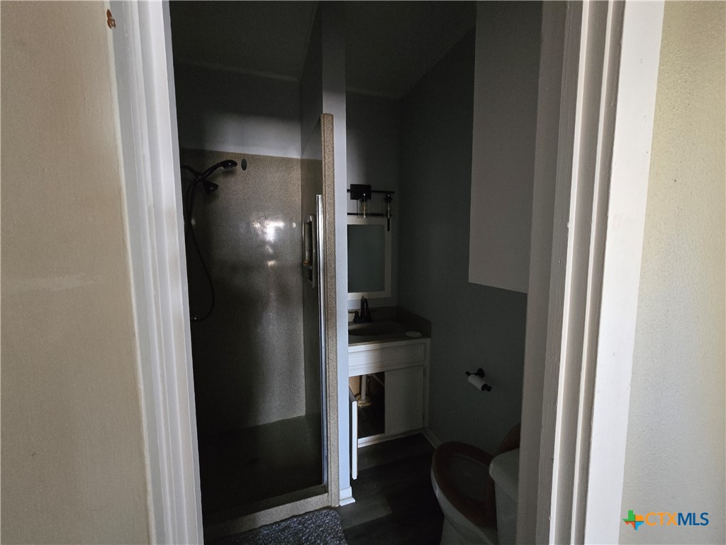 404 Fennimore Street Gatesville, TX 76528 - Photo 17 of 19 a bathroom with a sink and a mirror