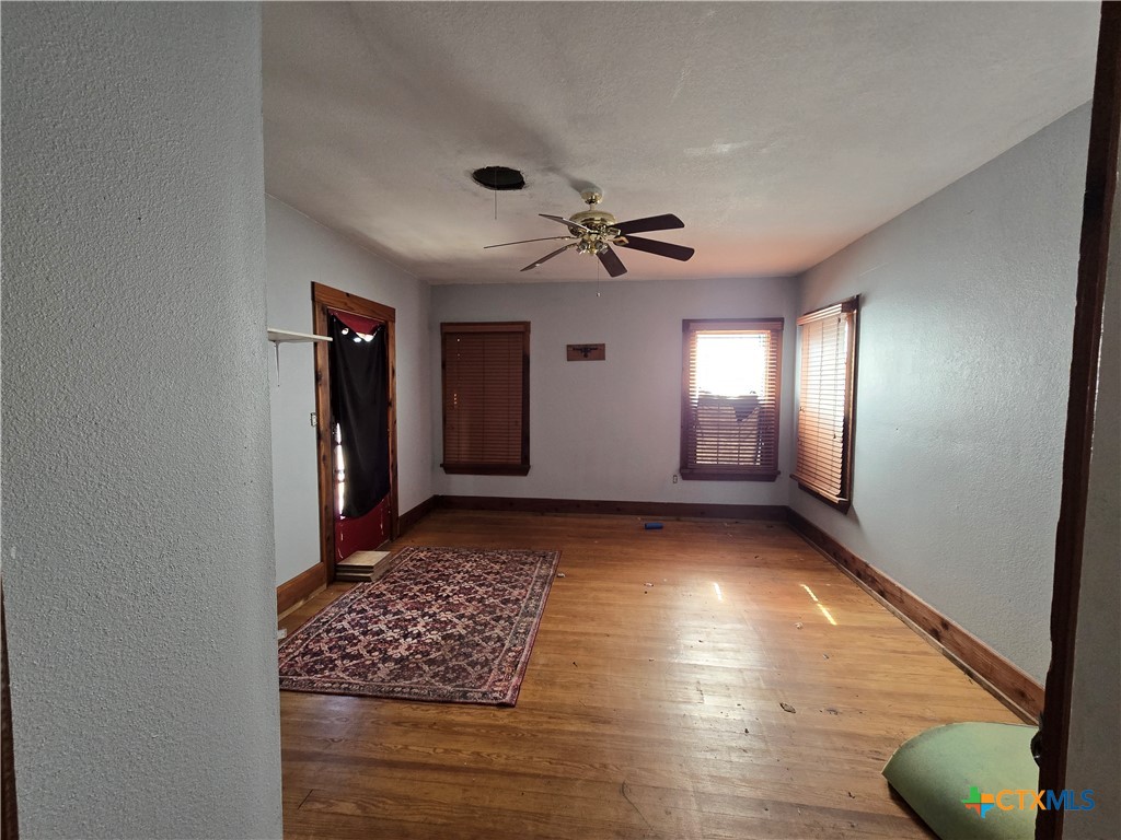 404 Fennimore Street Gatesville, TX 76528 - Photo 19 of 19 a view of wooden floor and windows in a room