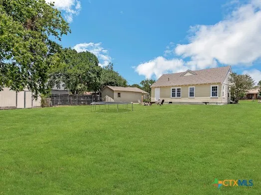a view of house with a big yard