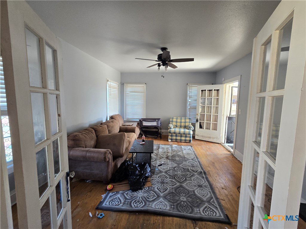 404 Fennimore Street Gatesville, TX 76528 - Photo 7 of 19 a living room with furniture rug and a chandelier