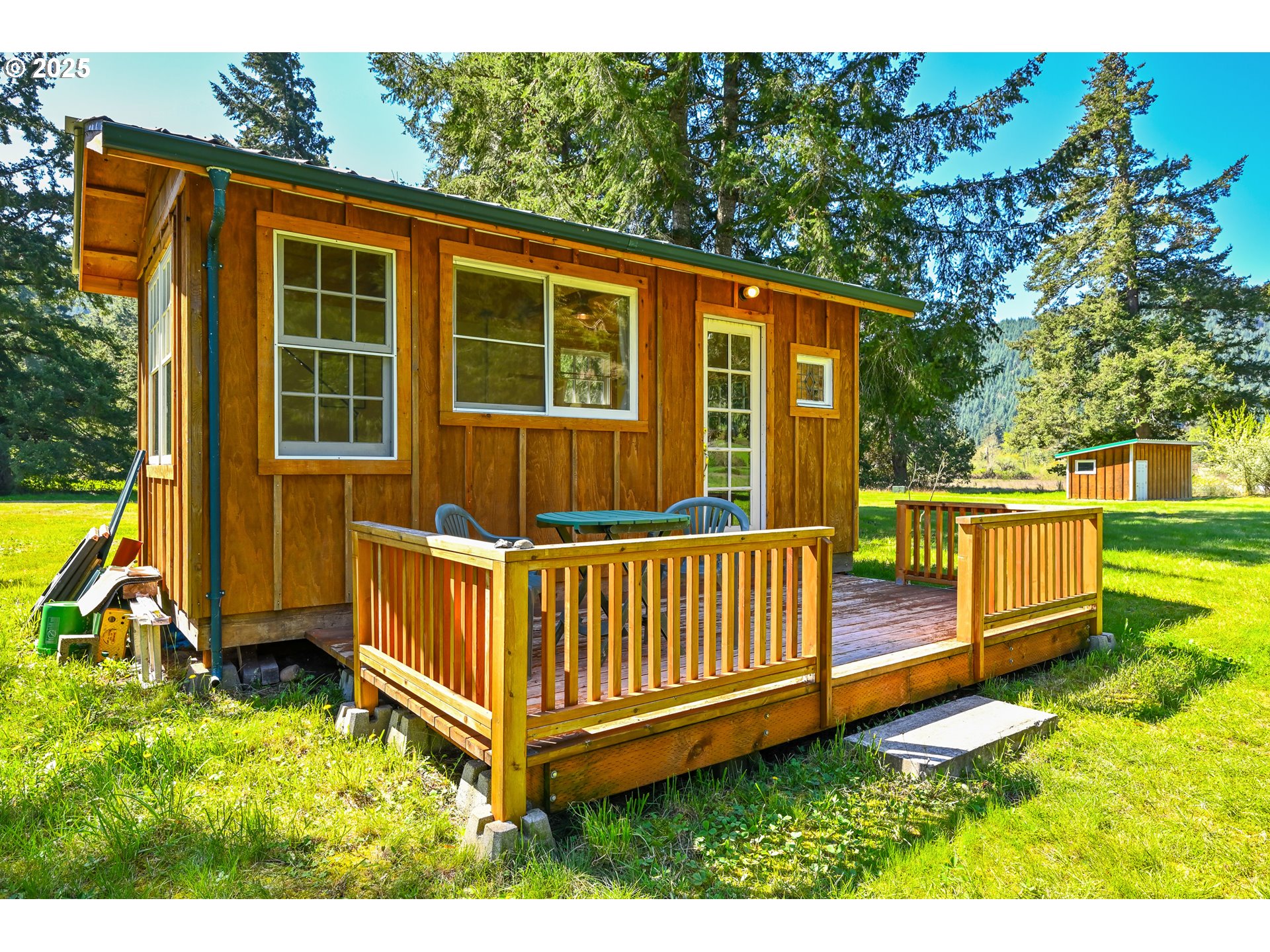 38305 Lower Brice Creek Road Dorena, OR 97434 - Photo 18 of 40 a view of a backyard with a small cabin