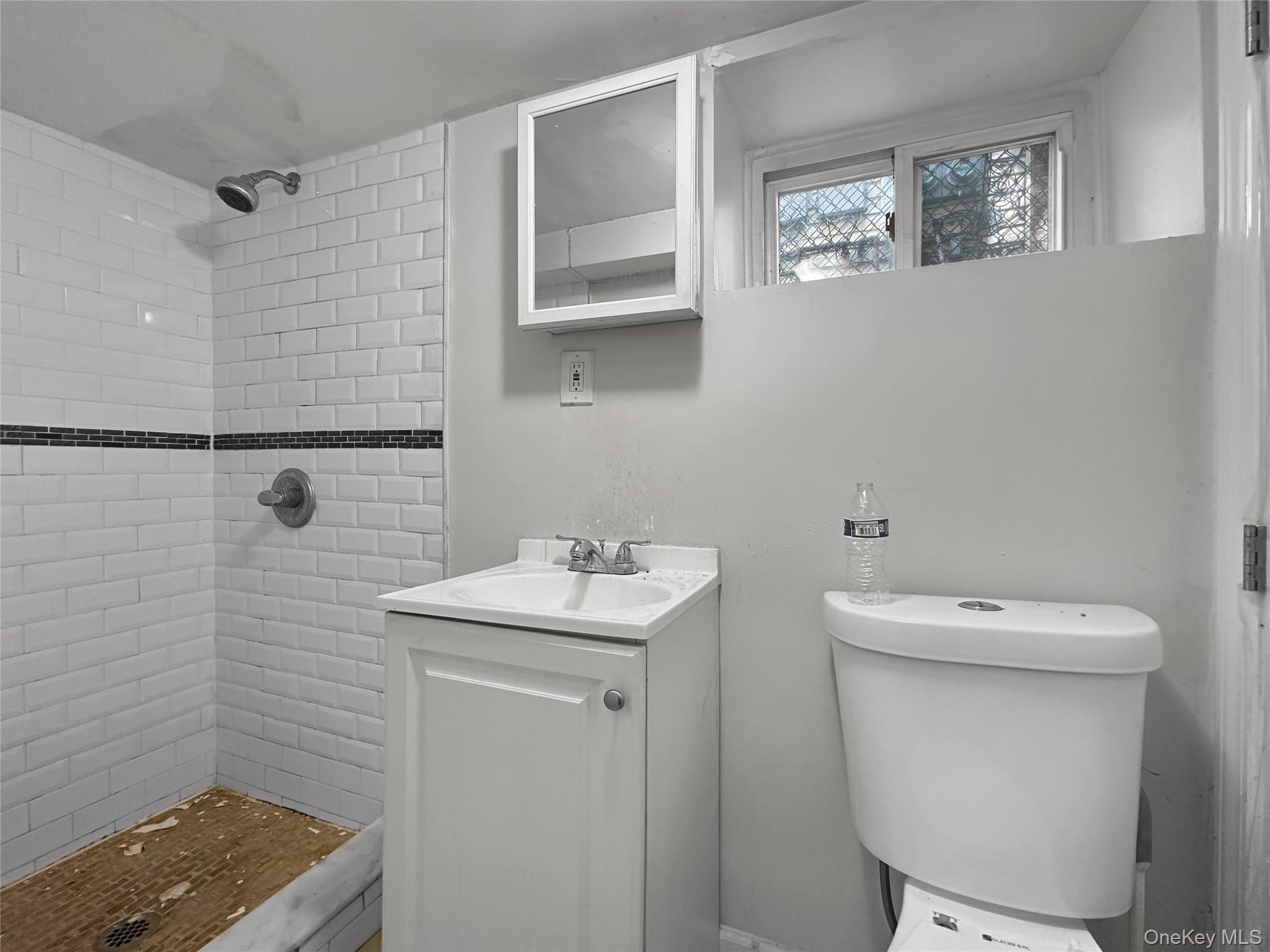 109-66 153rd Street Queens, NY 11433 - Photo 8 of 15 Bathroom with vanity and a stall shower
