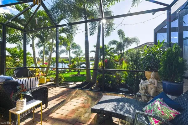 a view of a chairs and table in patio with wooden fence