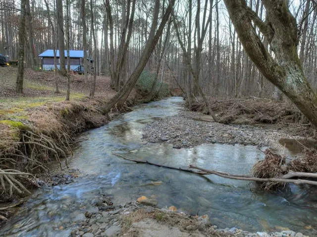 a view of a living room with furniture and a fireplace