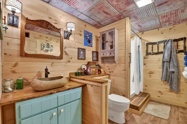 a living room with furniture a flat screen tv and kitchen view