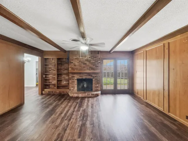 wooden floor in an empty room with a fireplace