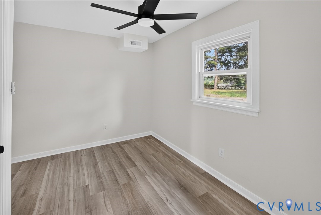 6581 Rural Point Road Mechanicsville, VA 23116 - Photo 26 of 58 Wood-finish flooring, white walls, and a black cei
