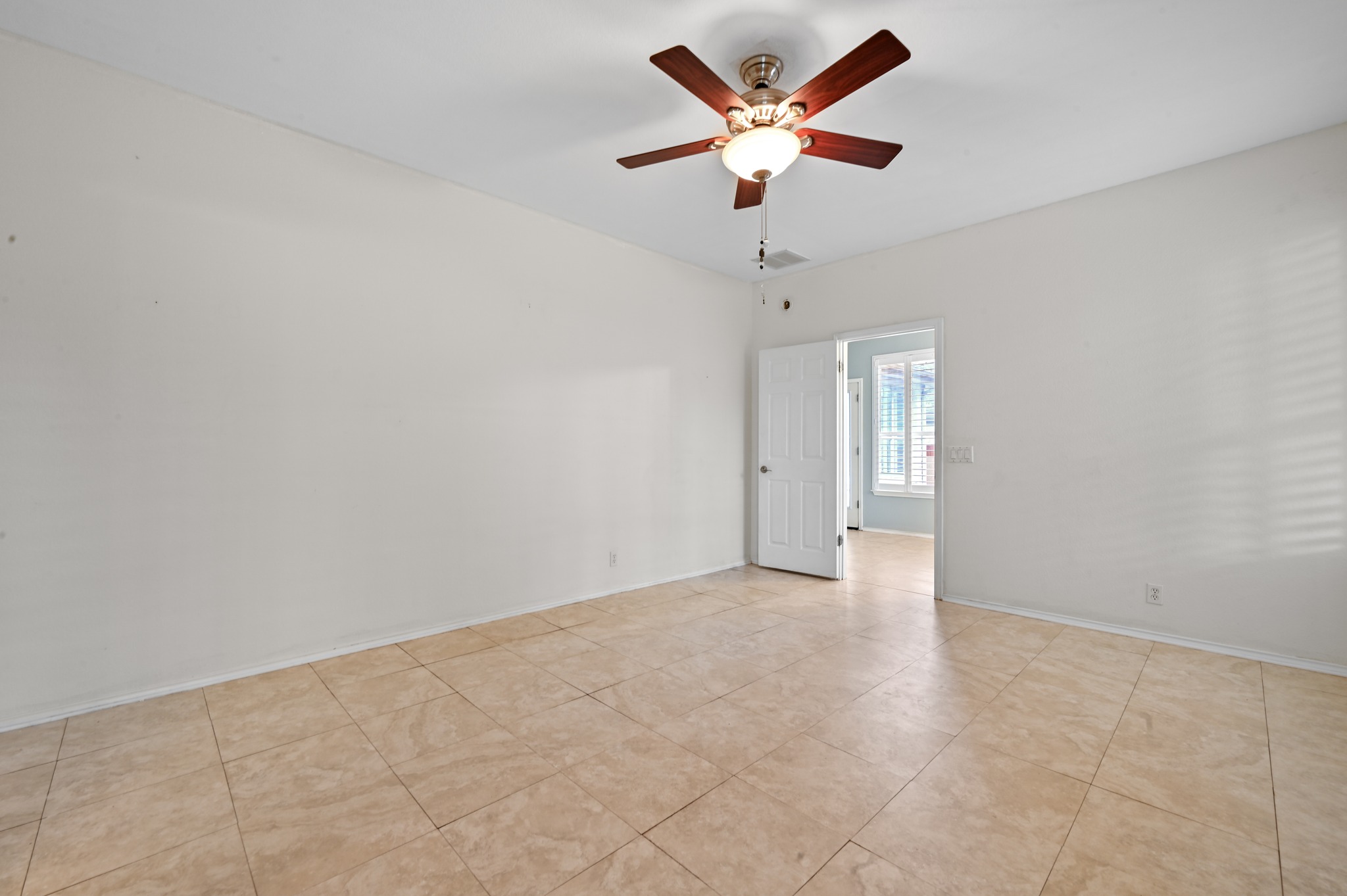 5313 Moon Shadow Drive Austin, TX 78735 - Photo 21 of 30 Neutral-toned tile flooring throughout the room with a ceiling fan light fixture