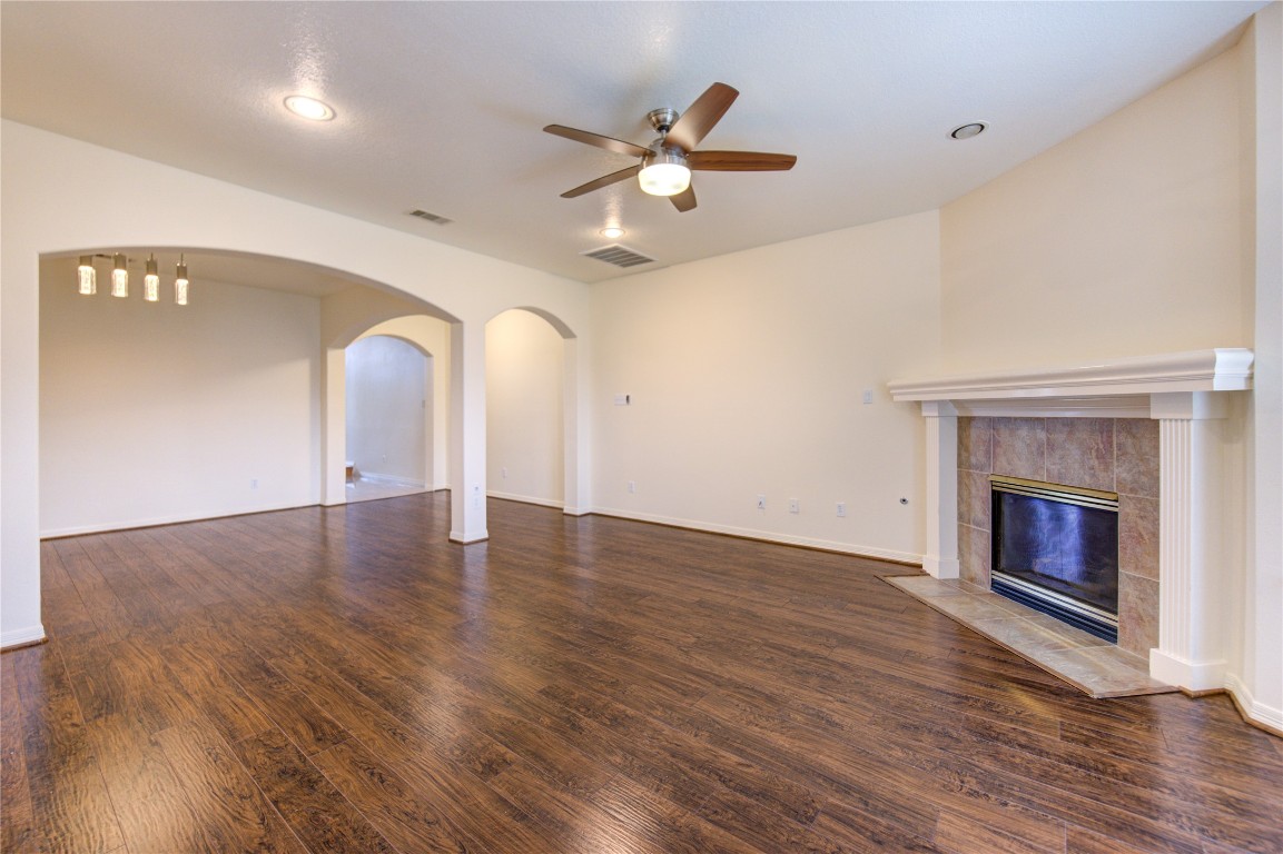 7611 South Linpar Court Houston, TX 77040 - Photo 13 of 49 a view of an empty room with wooden floor and a fireplace