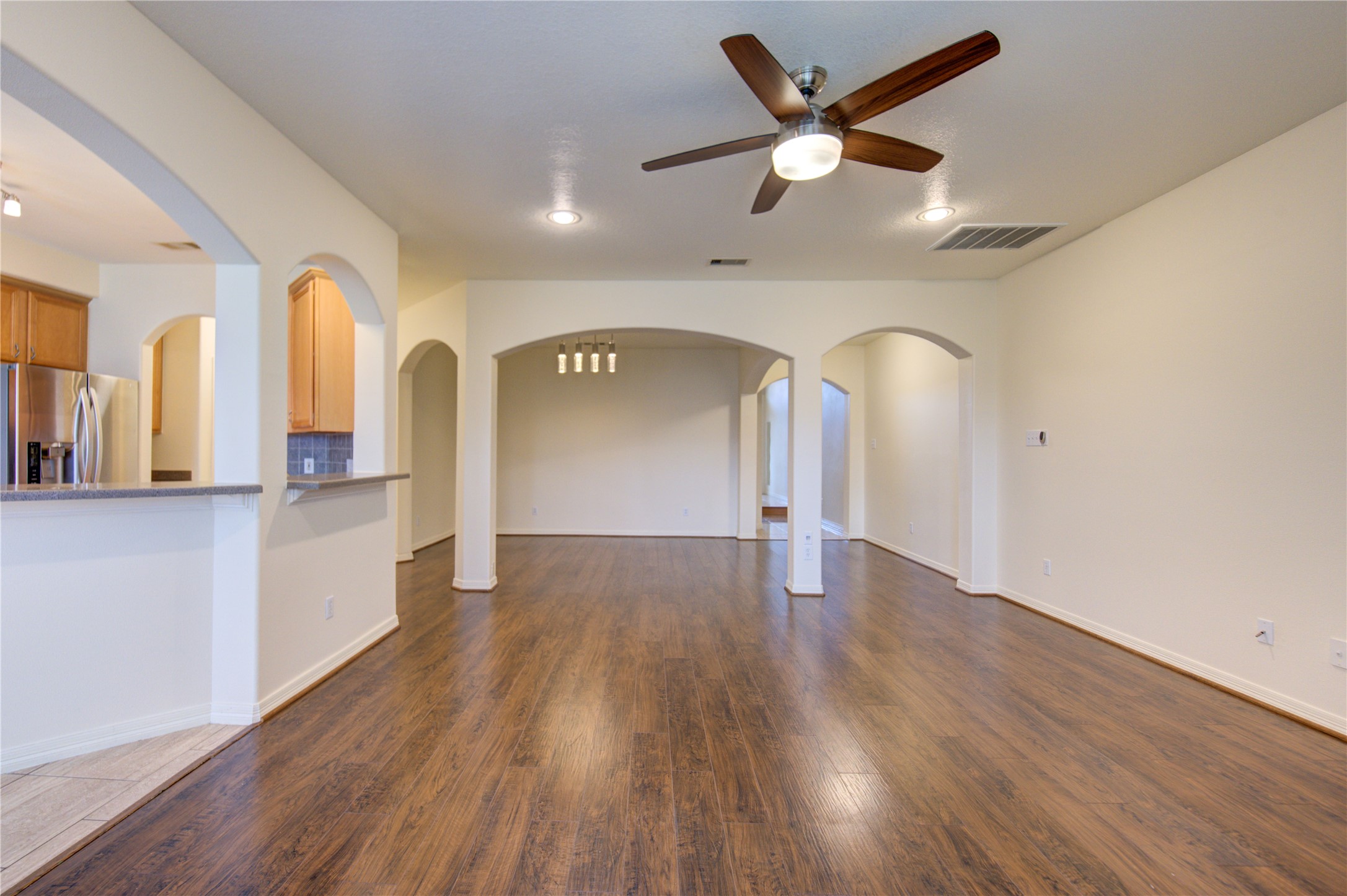 7611 South Linpar Court Houston, TX 77040 - Photo 14 of 48 wooden floor in an empty room with a window