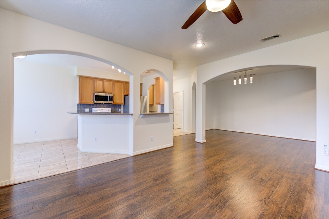 7611 South Linpar Court Houston, TX 77040 - Photo 15 of 49 a view of a kitchen with a microwave and wooden floor