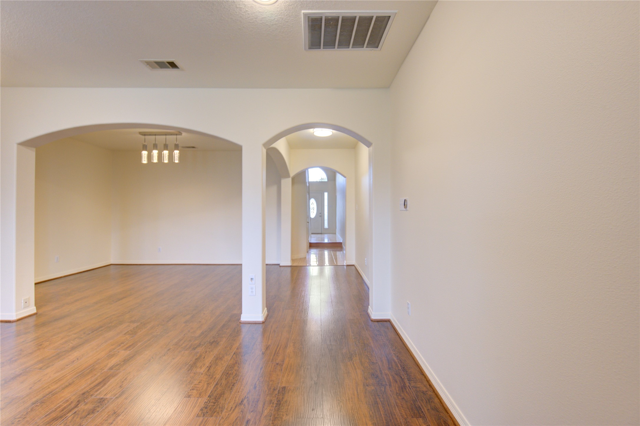 7611 South Linpar Court Houston, TX 77040 - Photo 22 of 48 a view of a hallway with wooden floor
