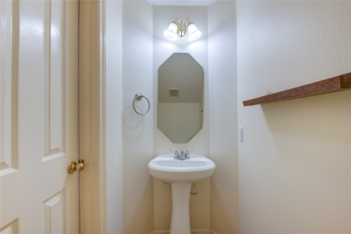7611 South Linpar Court Houston, TX 77040 - Photo 23 of 49 a bathroom with a sink and a mirror