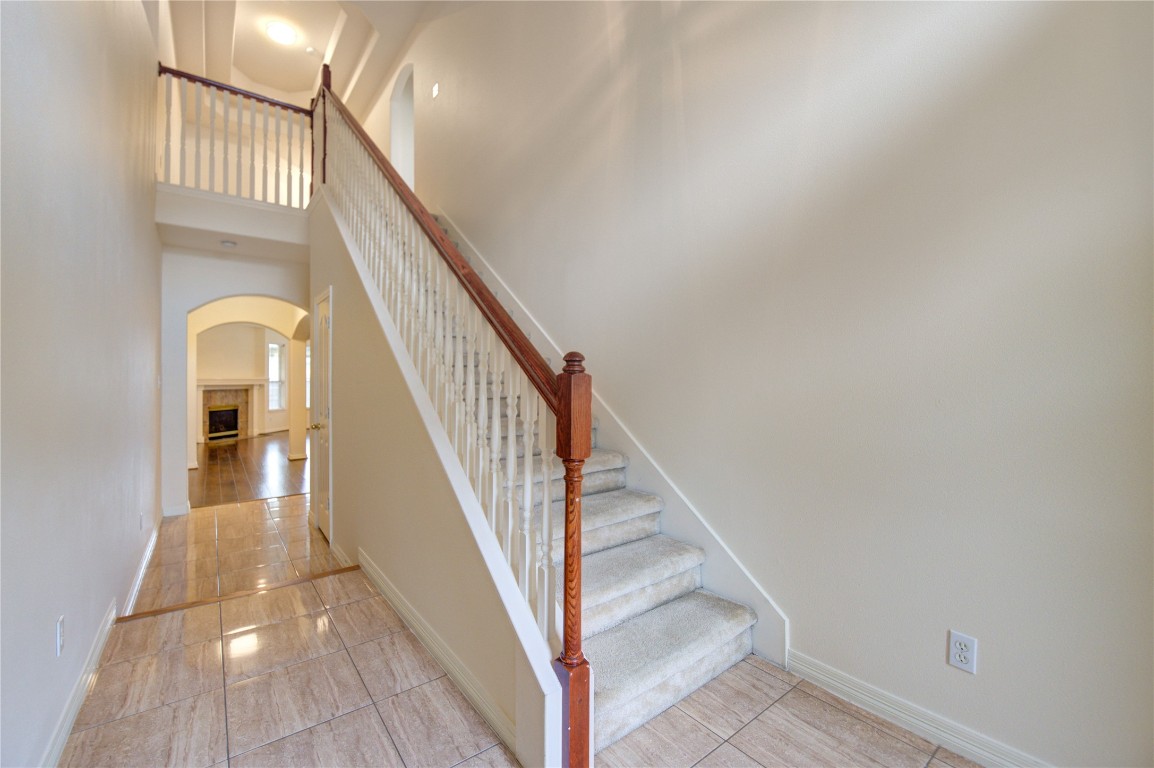 7611 South Linpar Court Houston, TX 77040 - Photo 24 of 49 a view of staircase with wooden floor and a rug