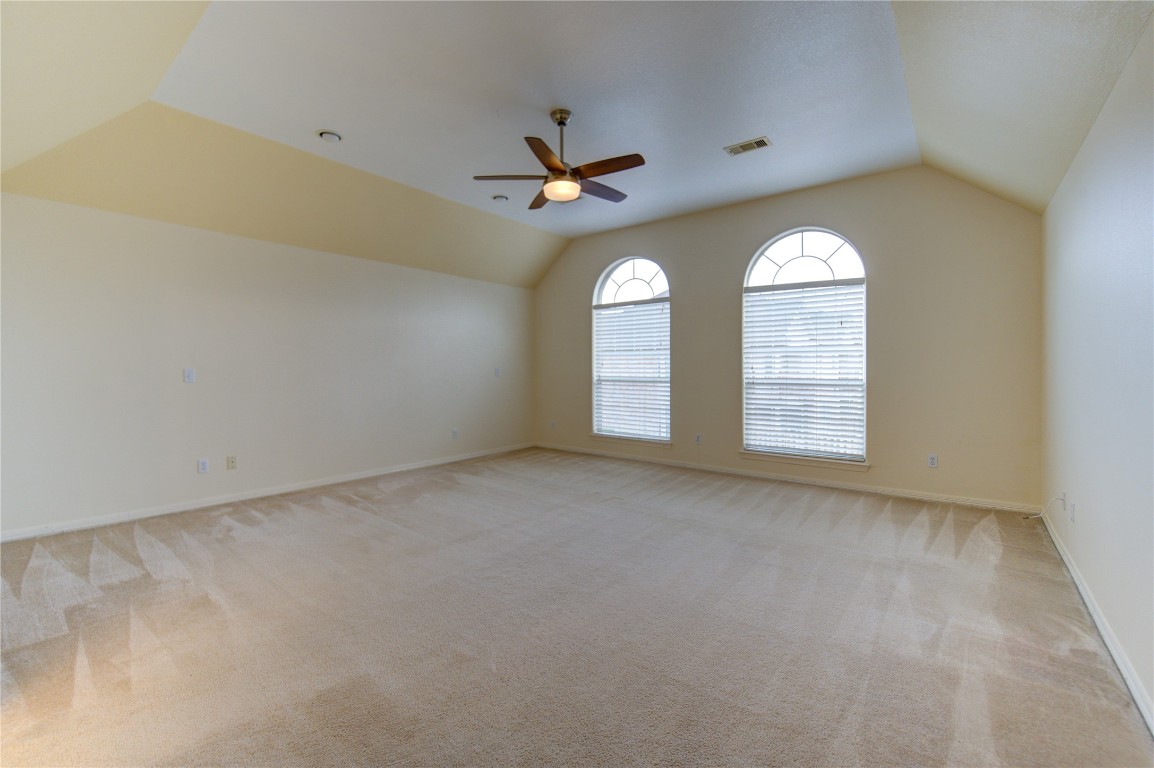 7611 South Linpar Court Houston, TX 77040 - Photo 30 of 49 an empty room with windows and ceiling fan