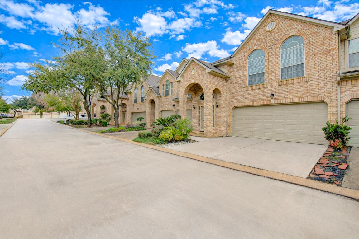 7611 South Linpar Court Houston, TX 77040 - Photo 3 of 49 a front view of a house with a yard and garage