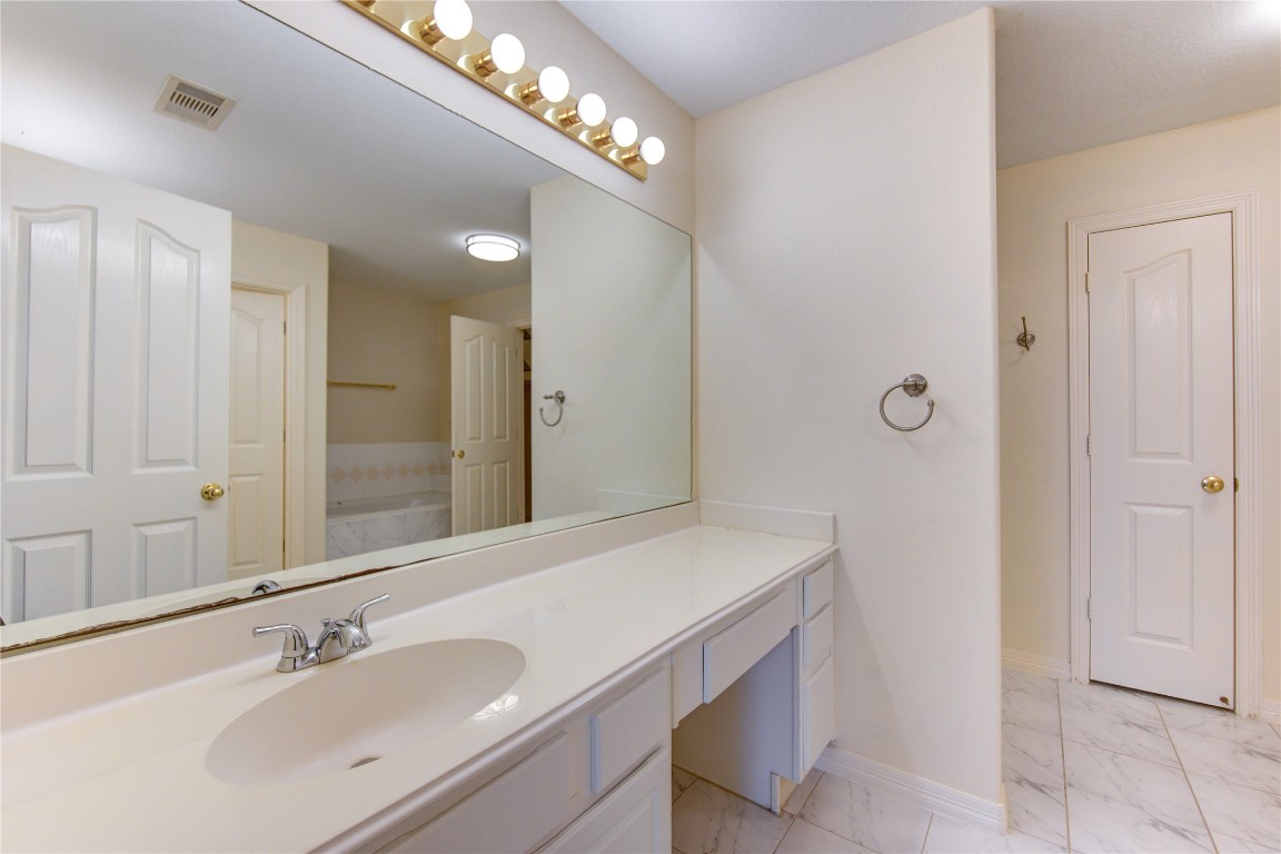 7611 South Linpar Court Houston, TX 77040 - Photo 33 of 49 a bathroom with a sink and a mirror