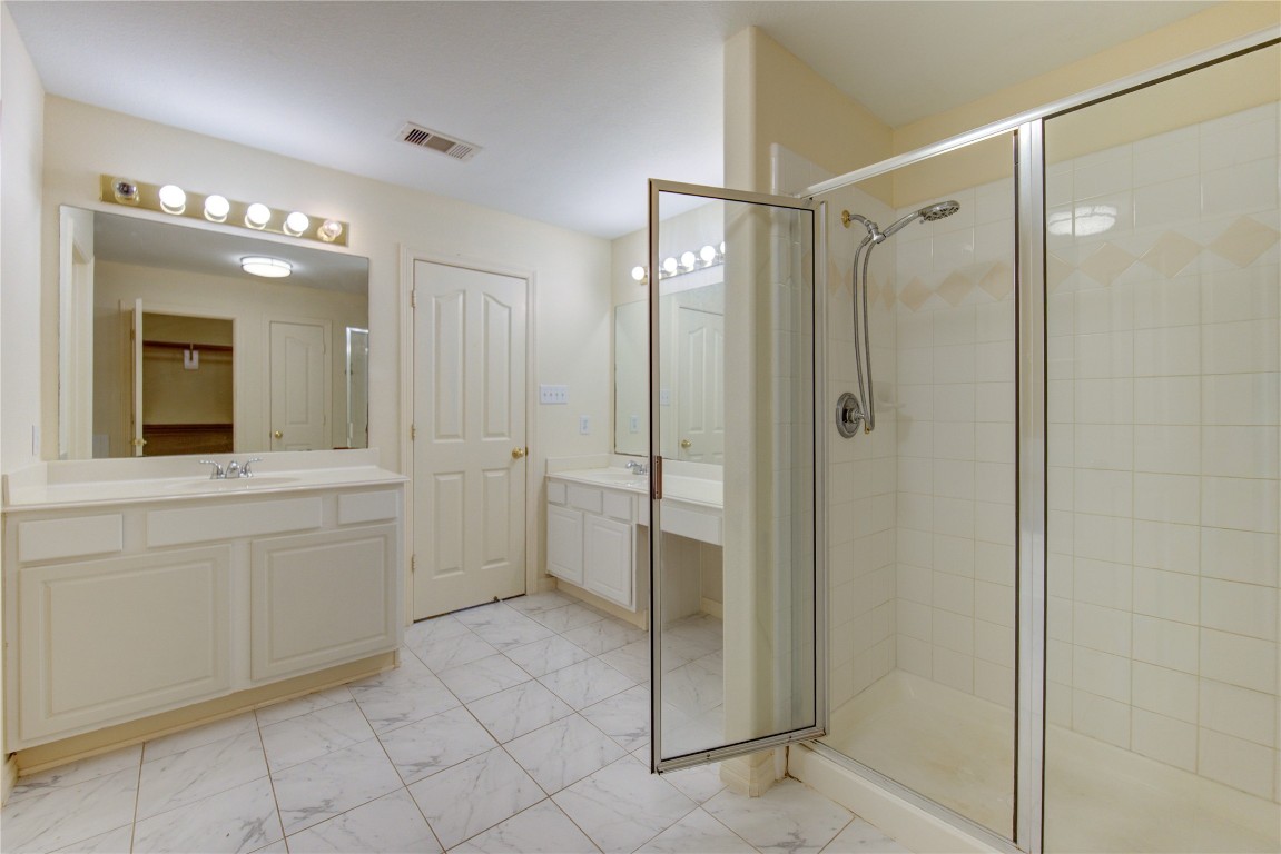 7611 South Linpar Court Houston, TX 77040 - Photo 35 of 49 a bathroom with a shower sink and mirror