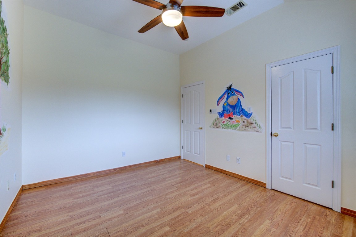 7611 South Linpar Court Houston, TX 77040 - Photo 40 of 49 an empty room with wooden floor and ceiling fan