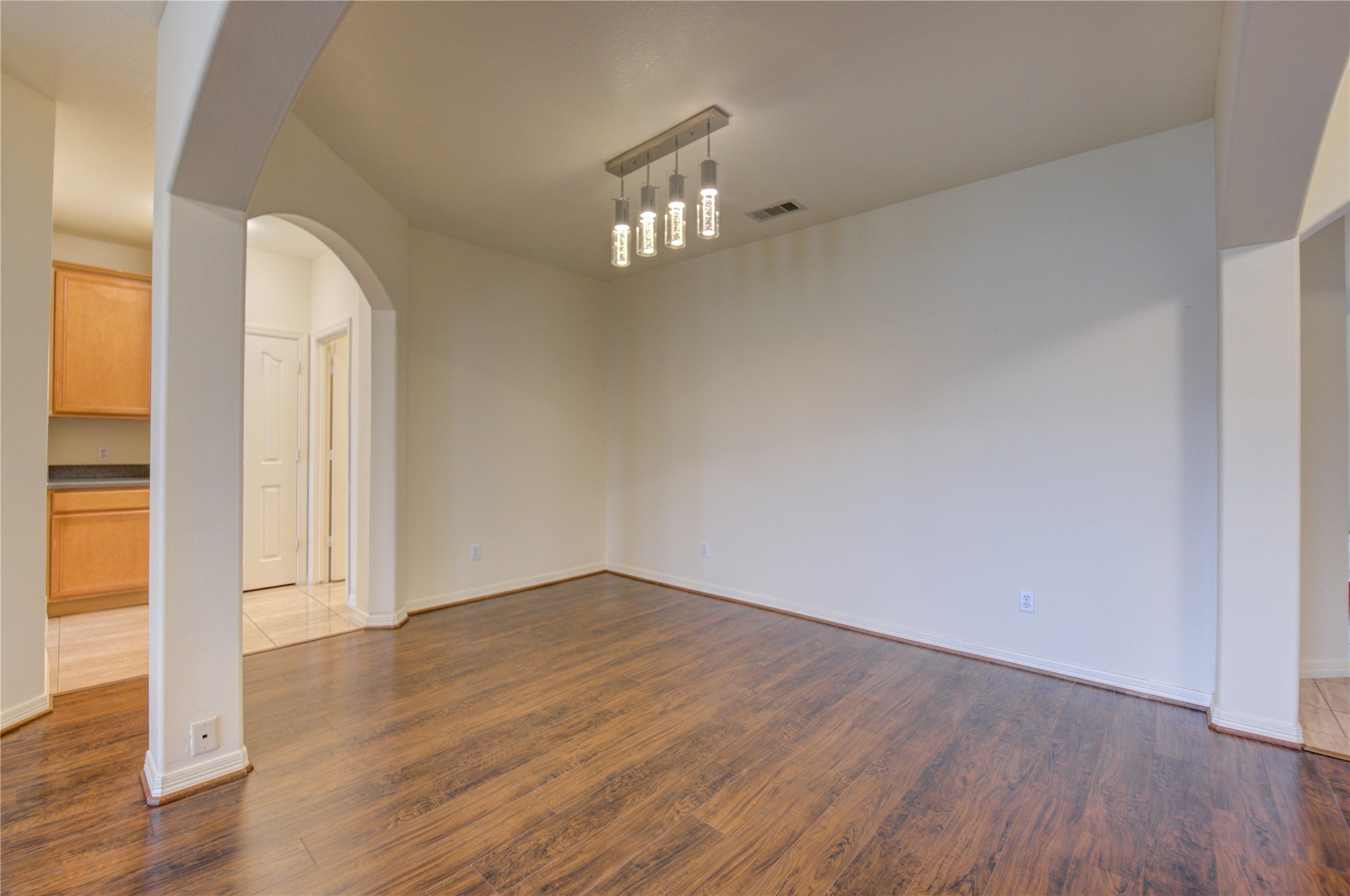 7611 South Linpar Court Houston, TX 77040 - Photo 9 of 48 an empty room with wooden floor and windows