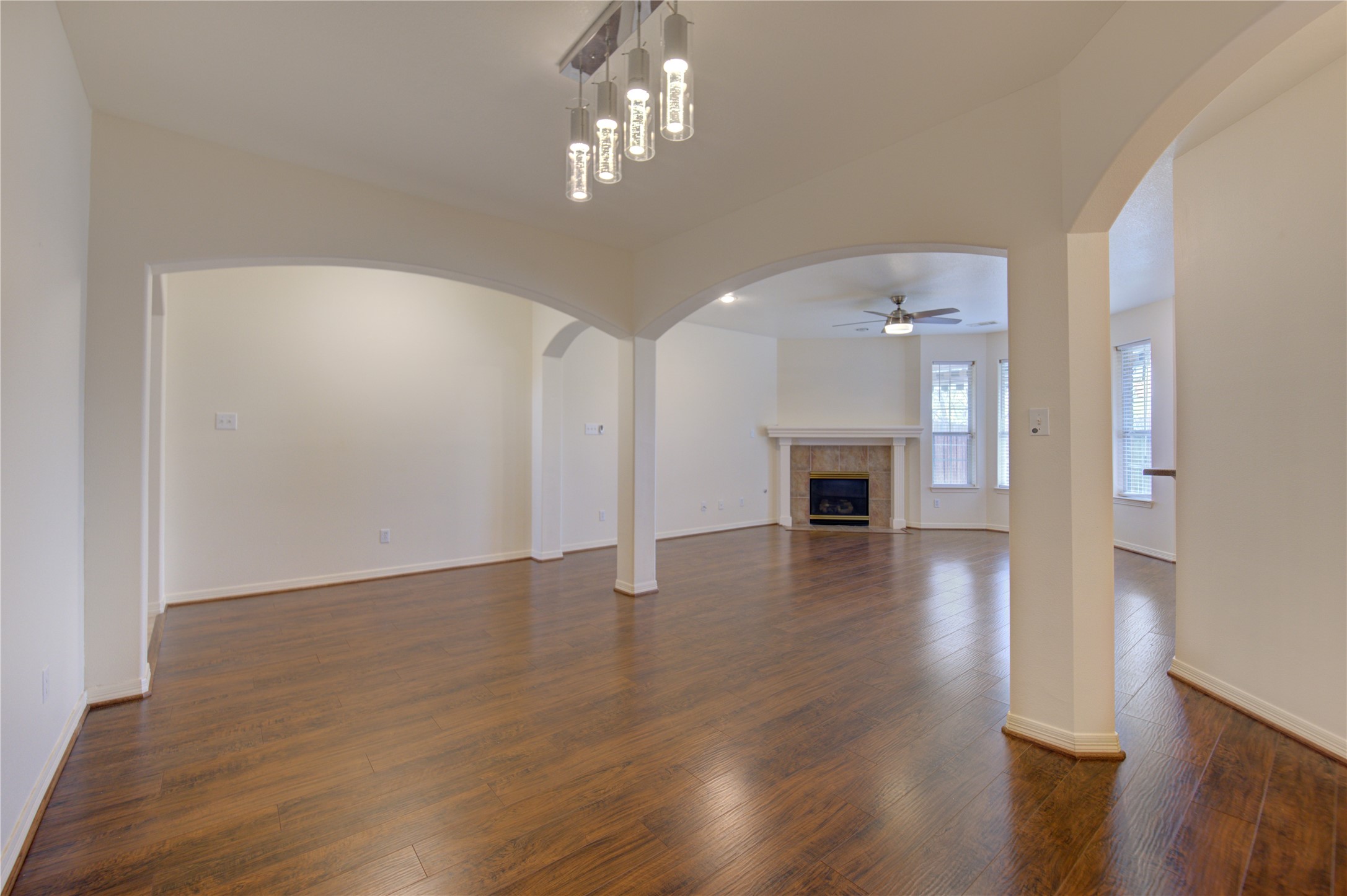 7611 South Linpar Court Houston, TX 77040 - Photo 10 of 48 wooden floor in an empty room with a fireplace
