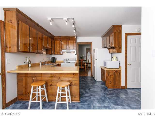 7317 Barkbridge Road Chesterfield, VA 23832 - Photo 11 of 24 a kitchen with stainless steel appliances granite countertop a sink and cabinets