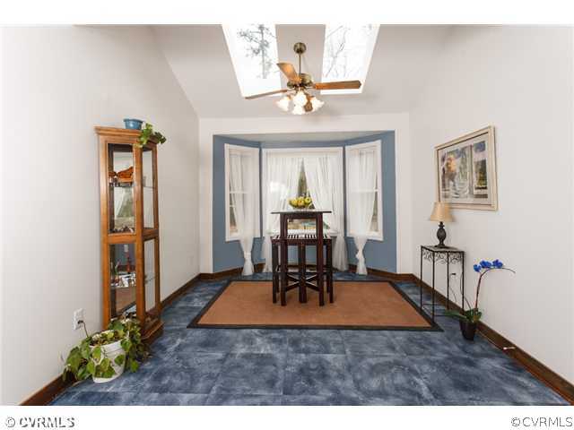 7317 Barkbridge Road Chesterfield, VA 23832 - Photo 10 of 24 a living room with furniture a dining table and paintings on the wall