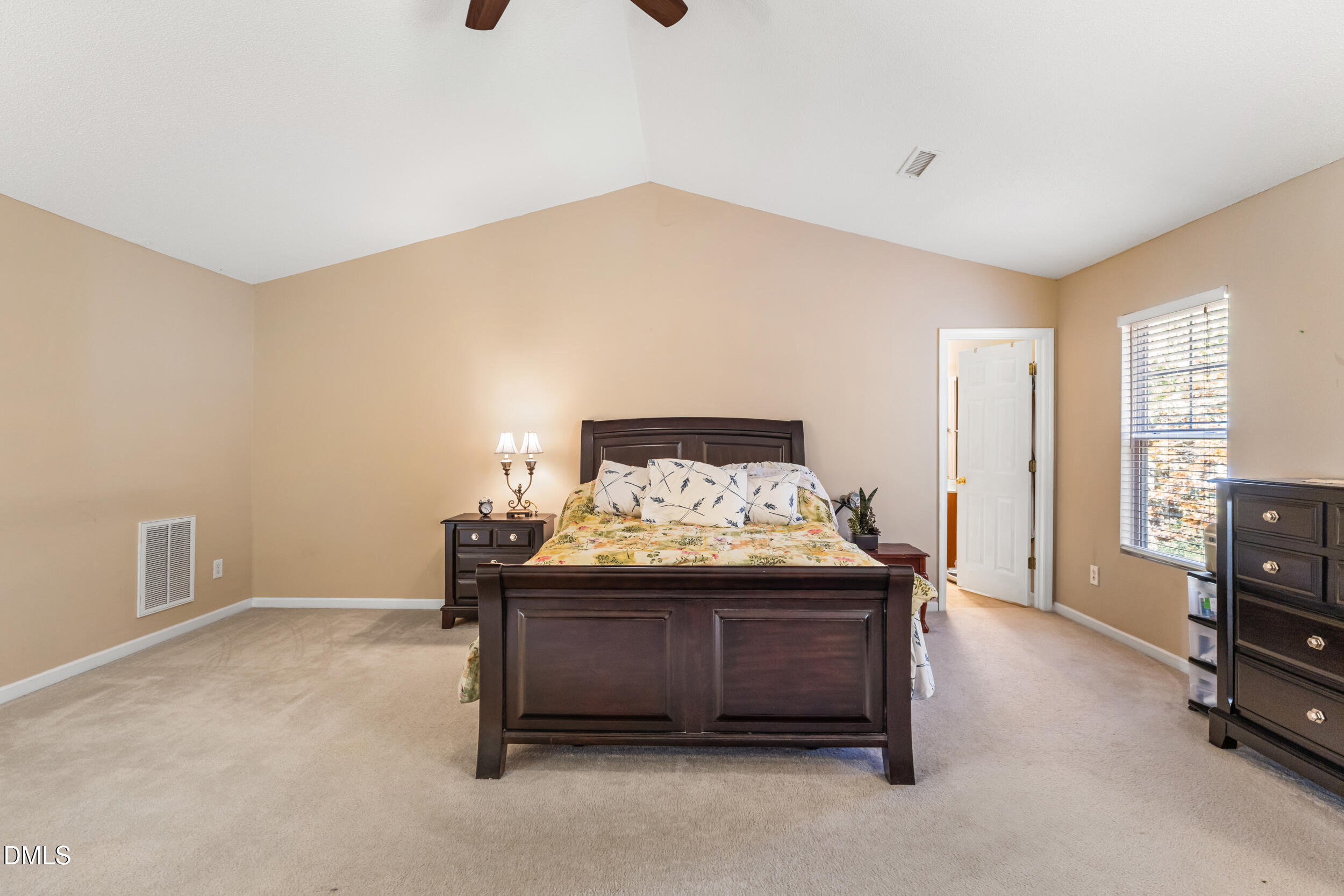 3748 Charleston Park Drive Raleigh, NC 27604 - Photo 16 of 34 a spacious bedroom with a bed and a tv on the dresser