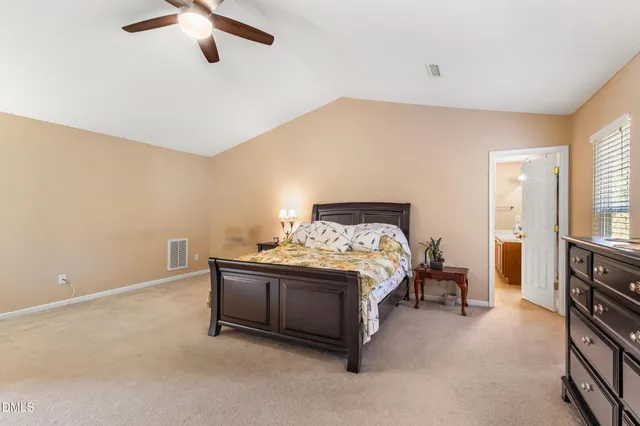 a bed sitting in a bedroom next to a window