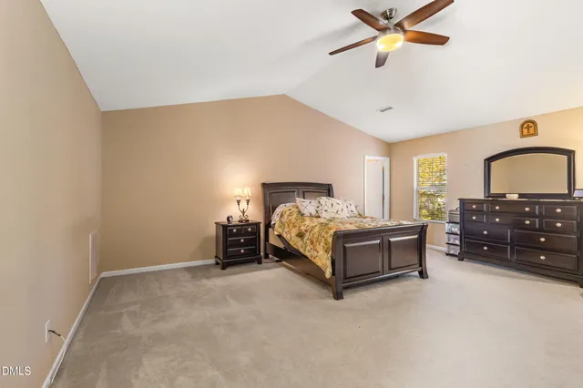 a spacious bedroom with a bed and window