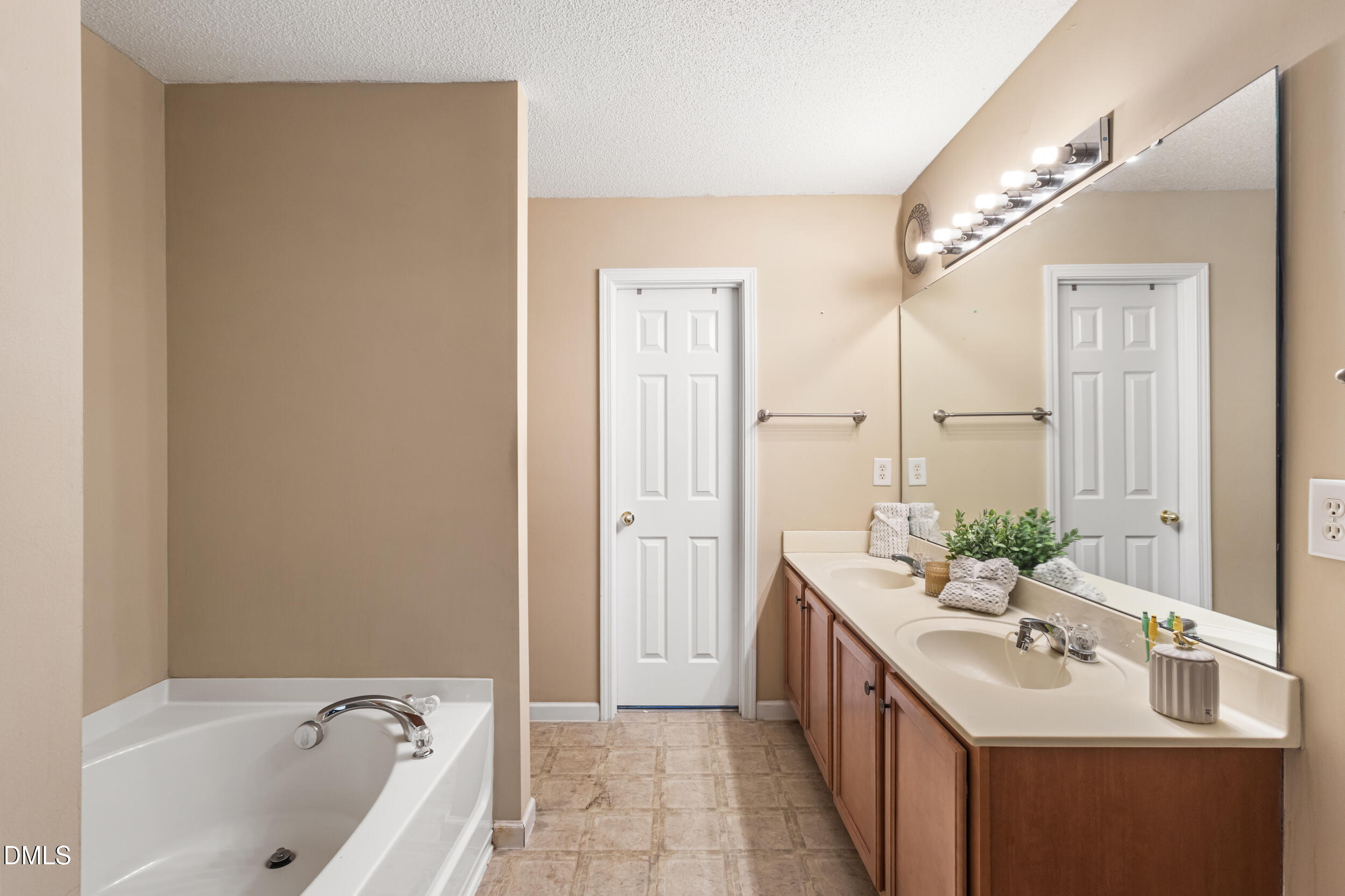 3748 Charleston Park Drive Raleigh, NC 27604 - Photo 20 of 34 a bathroom with a sink a mirror and a bathtub