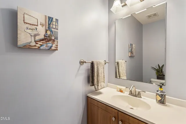 a bathroom with a sink vanity and mirror