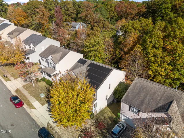 an aerial view of a house with a yard and garden