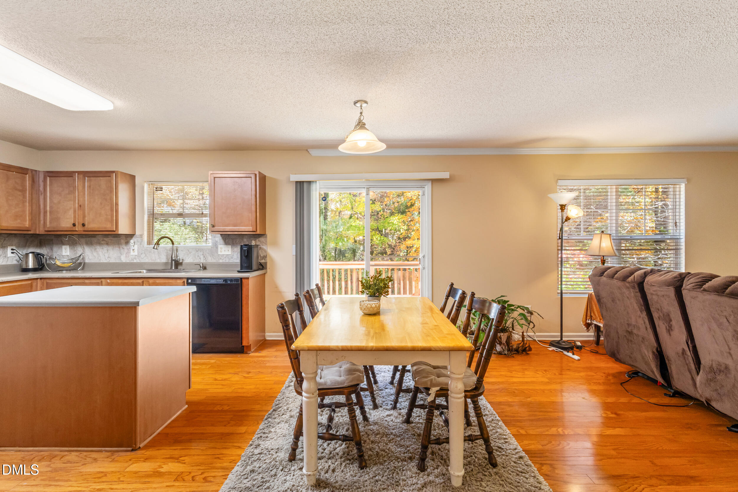 3748 Charleston Park Drive Raleigh, NC 27604 - Photo 10 of 34 a dining room with furniture a chandelier and wooden floor