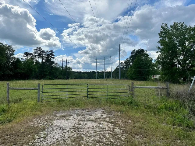 a view of outdoor space with green field and trees