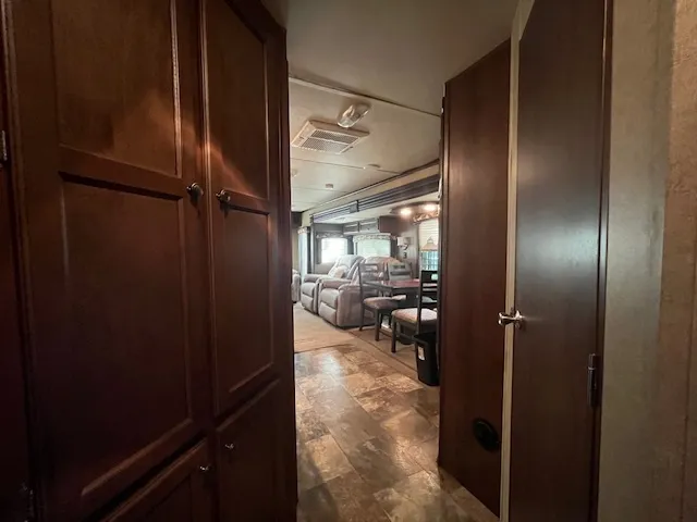 a living room with furniture a flat screen tv and gym equipment