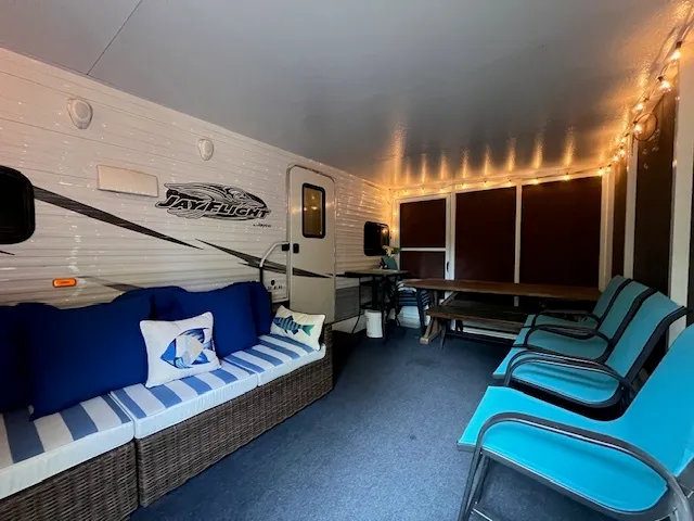 a view of a deck with wooden floor and outdoor seating