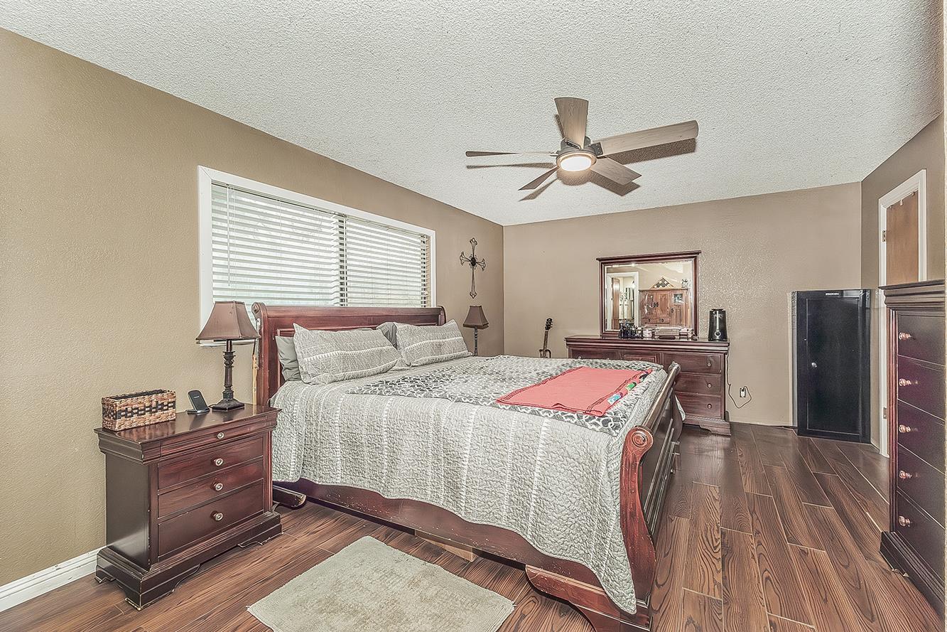 29545 Oak Meadow Road Tollhouse, CA 93667 - Photo 27 of 69 a bedroom with a bed and wooden floor