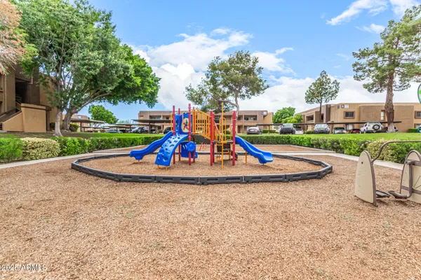 a view of park with slide and trees