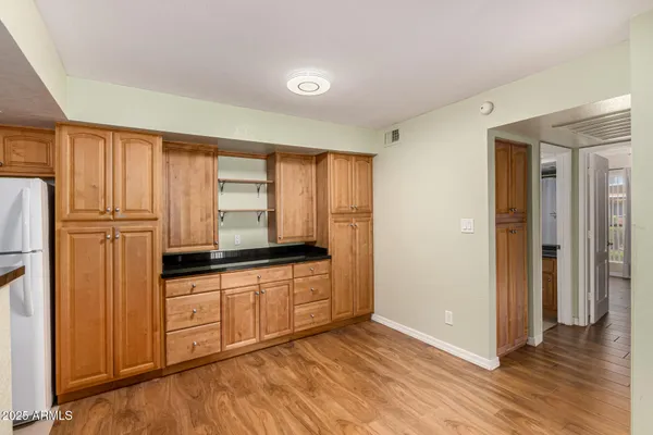 a kitchen with granite countertop wooden cabinets and granite counter tops