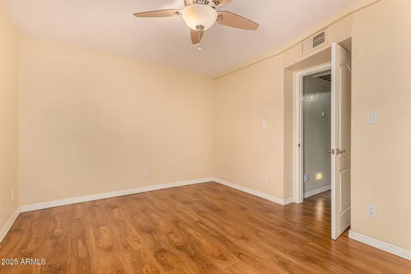 a view of an empty room with wooden floor