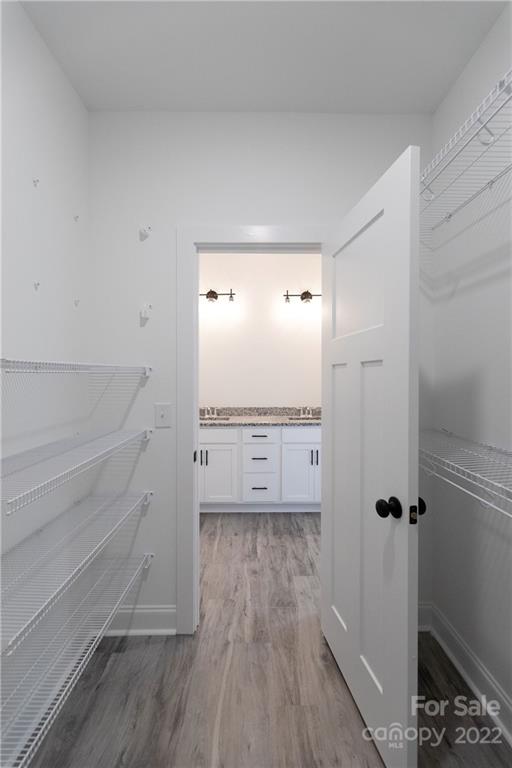 2231 State Rd S-46-1474, Unit 17 Clover, SC 29710 - Photo 13 of 20 a view of walk in closet with wooden floor