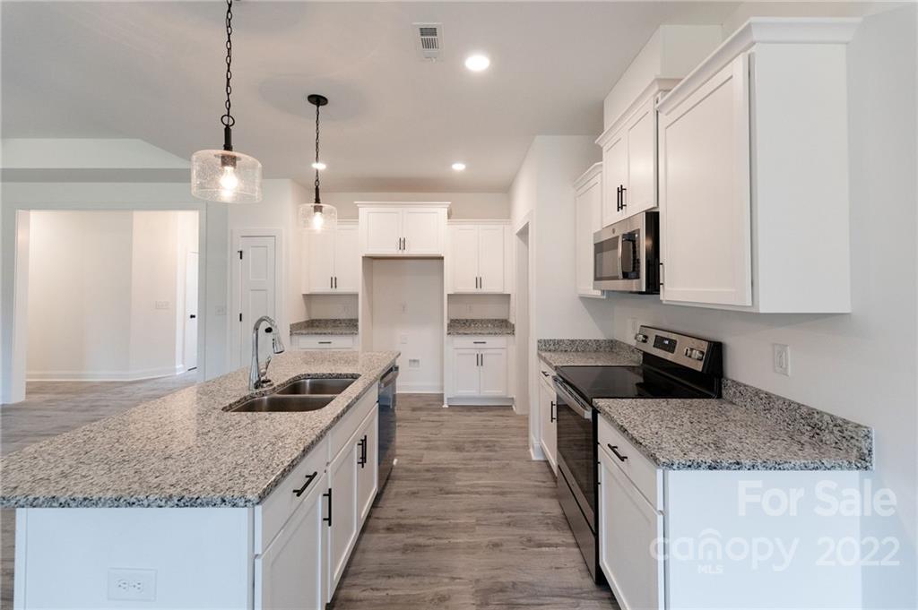2231 State Rd S-46-1474, Unit 17 Clover, SC 29710 - Photo 2 of 20 a kitchen with stainless steel appliances granite countertop a sink stove and refrigerator