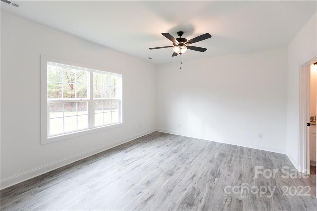 2231 State Rd S-46-1474, Unit 17 Clover, SC 29710 - Photo 9 of 20 an empty room with wooden floor closet and windows